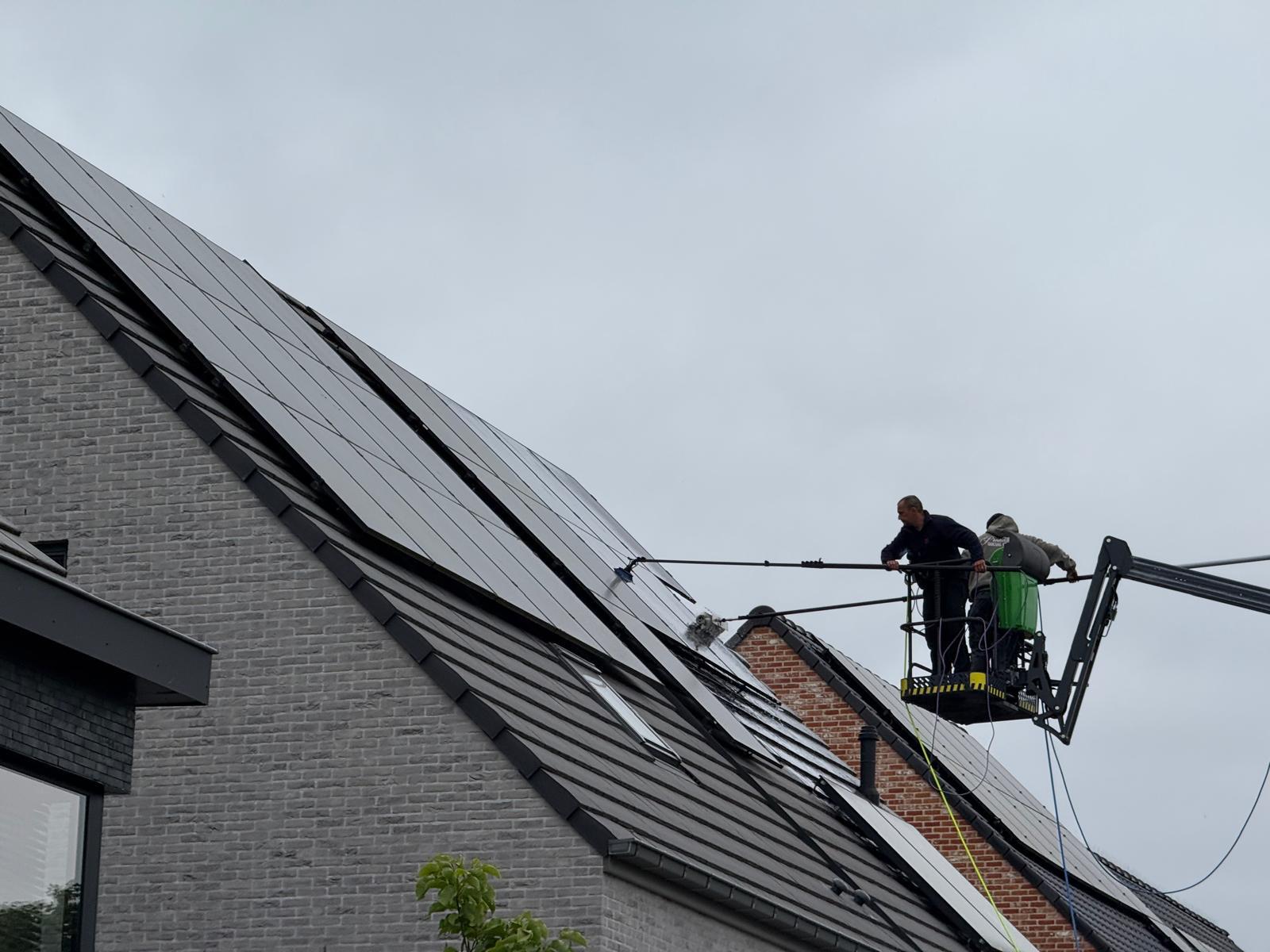 Detail van een reinigingsborstel op zonnepanelen vanaf een hoogwerker